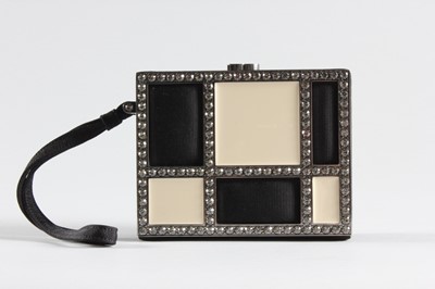 Lot 7 - A Chanel black faille and white enamelled...