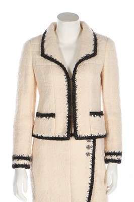 Lot 42 - A Chanel ivory bouclé wool suit, 2006,...