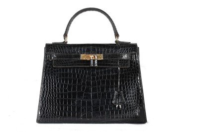 Lot 57 - An Hermès black crocodile Kelly bag, 1950s,...