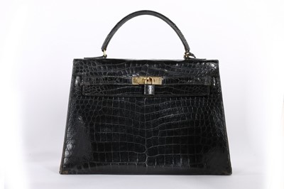 Lot 53 - An Hermès black crocodile Kelly bag, 1963,...
