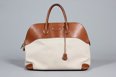 Lot 72 - An Hermès Bolide travel bag, of canvas and tan...