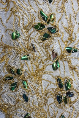 Lot 130 - An ivory tulle and beetle-wing adorned dress,...