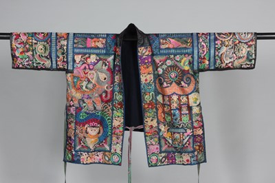 Lot 378 - An elaborately embroidered black glazed cotton...