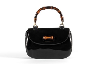 Lot 2 - A Gucci black patent leather handbag with cane...