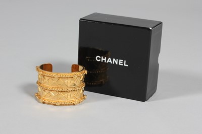 Lot 28 - A Chanel gilt bangle, 1980s, marked Chanel,...