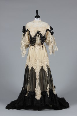 Lot 41 - An ivory tapelace and black chiffon evening...