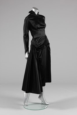 Lot 64 - A Jacques Fath couture black satin dinner gown,...