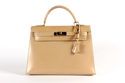 Lot 17 - An Hermès light tan box calf leather Kelly bag,...