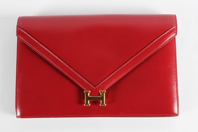 Lot 8 - An Hermès wine leather envelope shaped clutch...