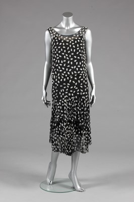Lot 77 - A finely beaded black chiffon cocktail dress,...