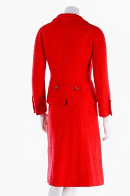 Lot 140 - A Chanel couture bright red tweed suit, 1974,...