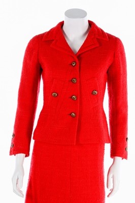 Lot 140 - A Chanel couture bright red tweed suit, 1974,...