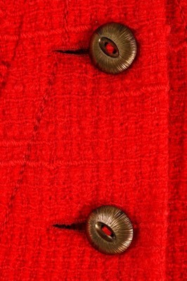 Lot 140 - A Chanel couture bright red tweed suit, 1974,...