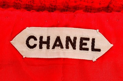 Lot 140 - A Chanel couture bright red tweed suit, 1974,...