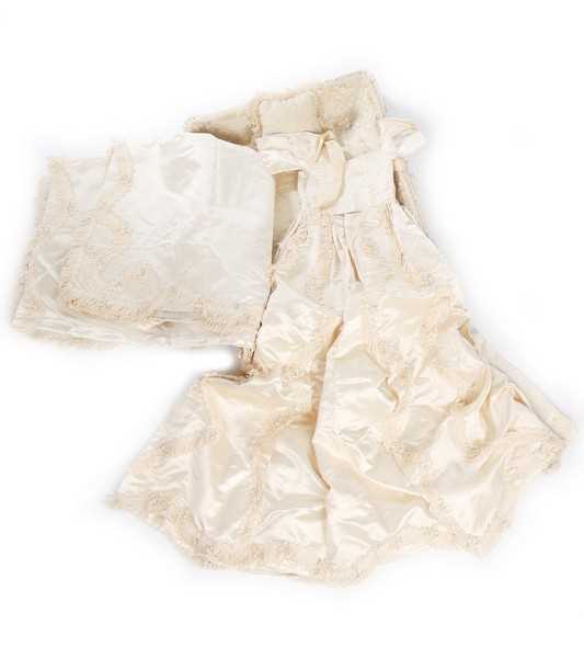 Lot 27 - A quilted ivory silk layette basket and...