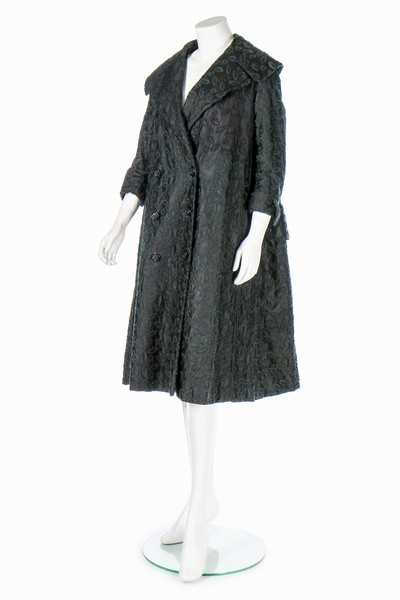 Lot 85 - A Jacques Fath embroidered black satin tent coat, 1954
