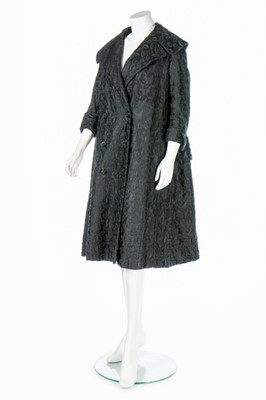 Lot 196 - A Jacques Fath embroidered black satin tent coat, 1954