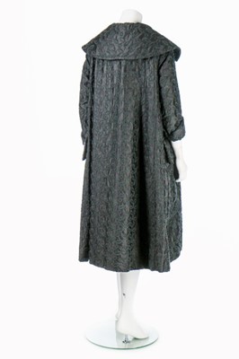 Lot 85 - A Jacques Fath embroidered black satin tent coat, 1954