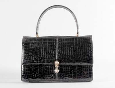 Lot 83 - A black crocodile handbag, early 1960s,...