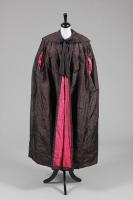 Lot 85 - An aubergine silk taffeta cape, late...