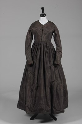 Lot 89 - A smoke grey-brown silk taffeta dress, early...