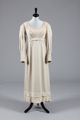 Lot 76 - An oyster-pink figured silk gown, circa 1815,...