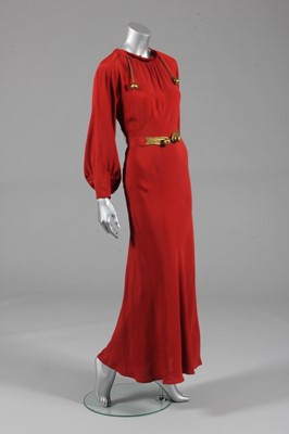 Lot 100 - A burnt orange crpe evening gown, possibly a...