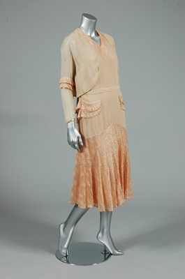 Lot 61 - A pale apricot and ivory chiffon and lace...