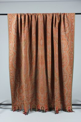 Lot 83 - A woven wool shawl of Paisley design, circa...