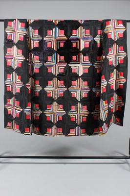 Lot 91 - A log cabin design patchwork coverlet, circa...