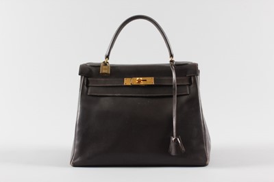 Lot 16 - An Hermès chocolate brown leather Kelly bag,...