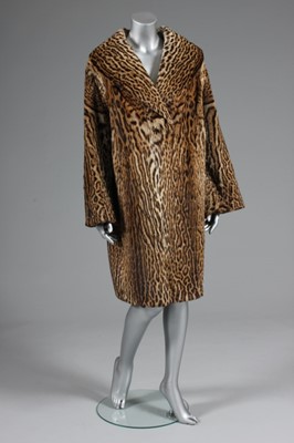 Lot 90 - An ocelot swing coat, late 1950s, with shawl...
