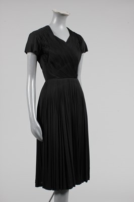 Lot 55 - A Madame Grès black jersey cocktail dress,...