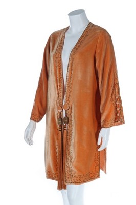Lot 104 - An orange velvet evening jacket, 1920s, the...