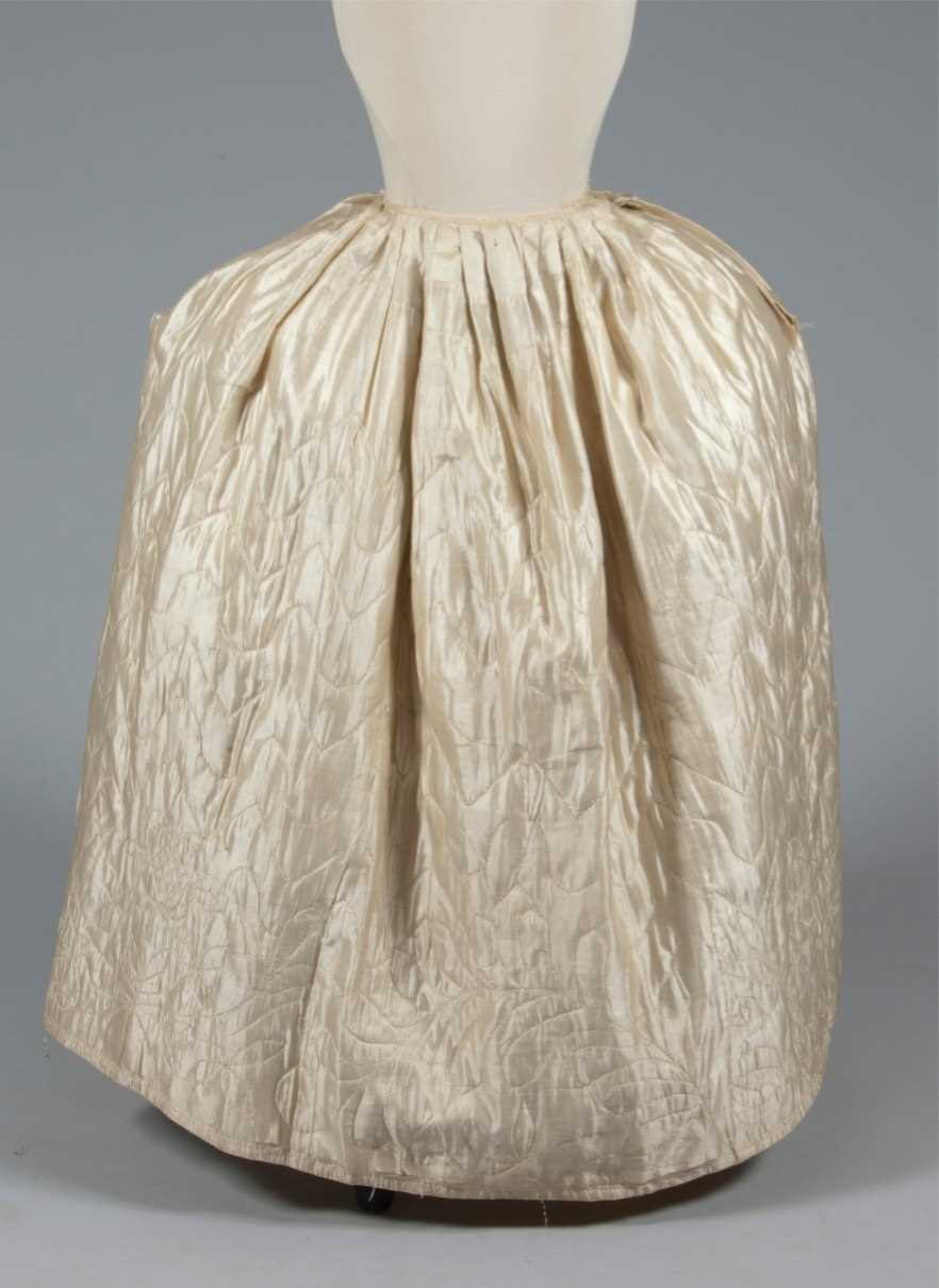 Lot 49 - A quilted ivory silk petticoat, circa 1760-80,...