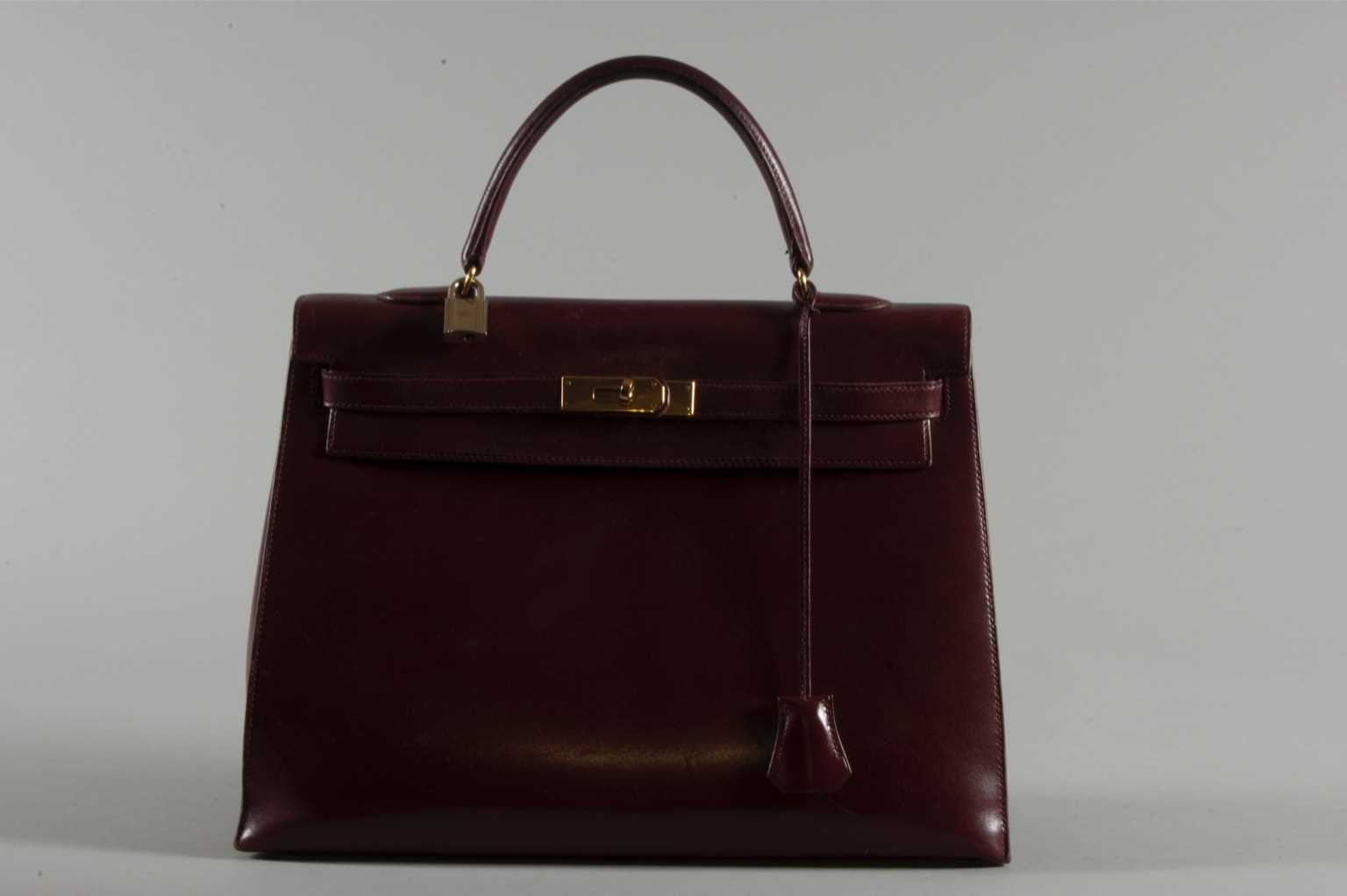 Lot 3 - A large Hermès burgundy leather Kelly bag,...