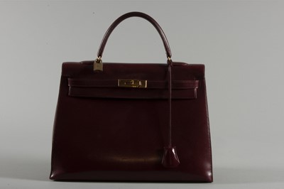 Lot 3 - A large Hermès burgundy leather Kelly bag,...