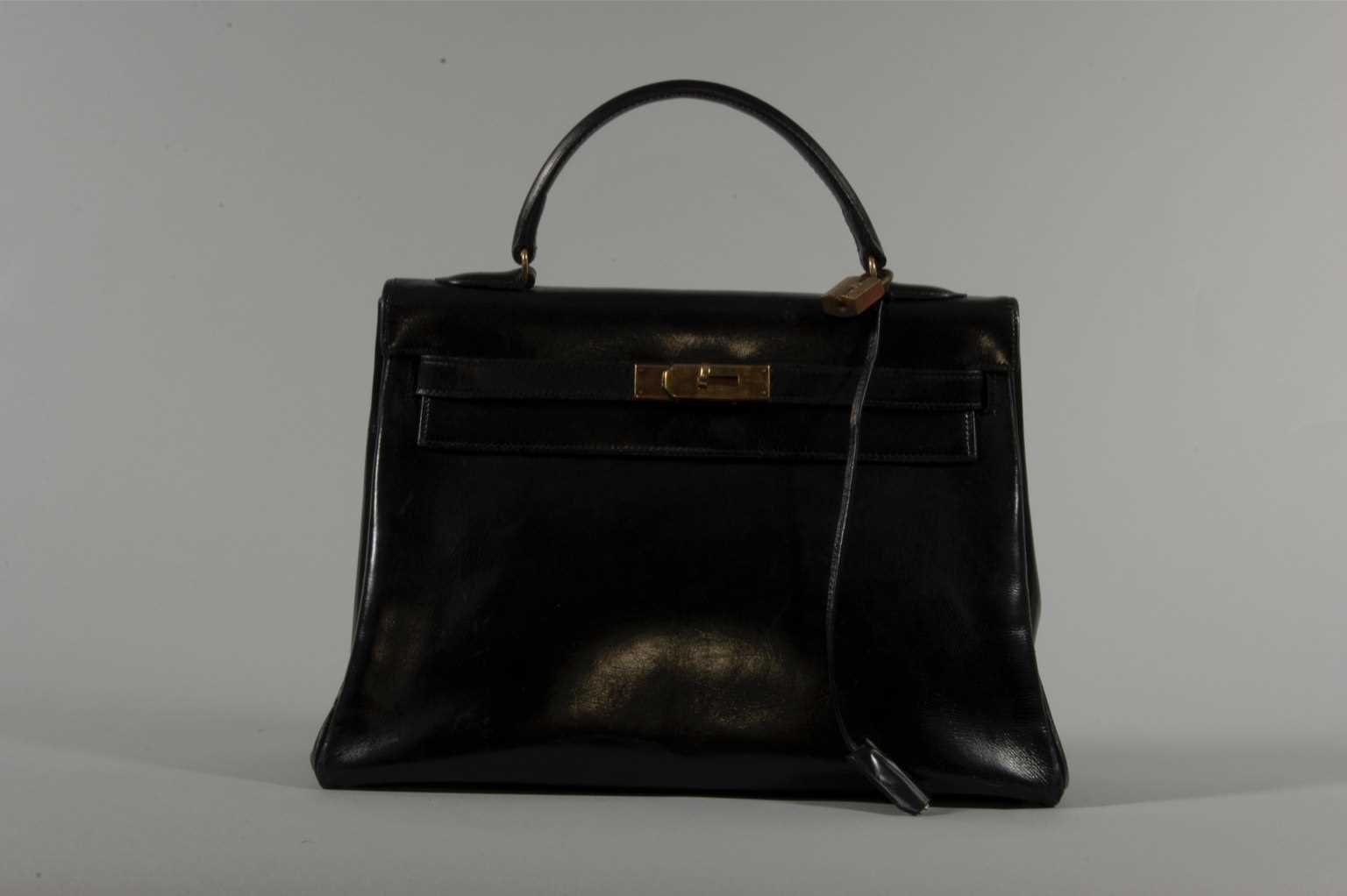 Lot 15 - An Hermès black box-leather Kelly bag, 1960s,...