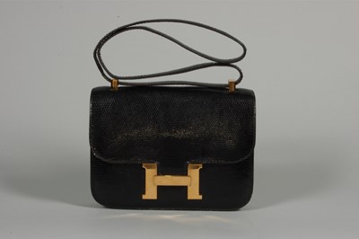 Lot 11 - An Hermès black lizard 'Constance' bag, 1972,...