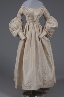 Lot 56 - An ivory silk bridal gown, circa 1838, with...