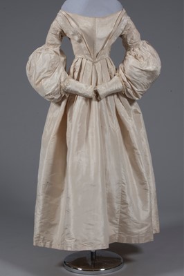 Lot 56 - An ivory silk bridal gown, circa 1838, with...