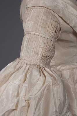 Lot 56 - An ivory silk bridal gown, circa 1838, with...