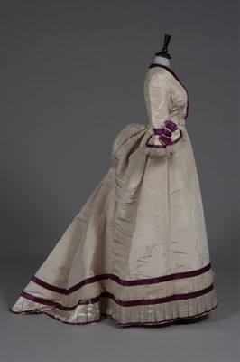 Lot 48 - A fine ivory moiré and wine satin gown with...