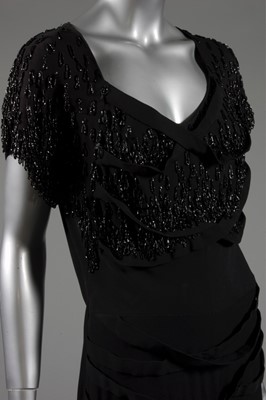 Lot 124 - A Gilbert Adrian beaded black wool crepe...