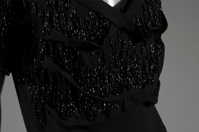 Lot 124 - A Gilbert Adrian beaded black wool crepe...