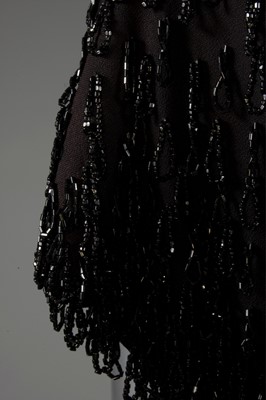 Lot 124 - A Gilbert Adrian beaded black wool crepe...