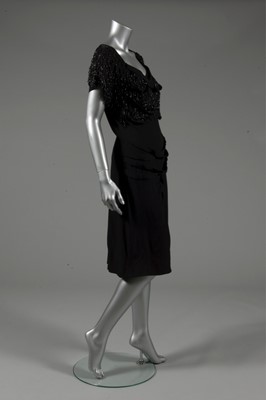 Lot 124 - A Gilbert Adrian beaded black wool crepe...