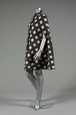 Lot 212 - A Pauline Trigre woven window-pane cape, 1974,...