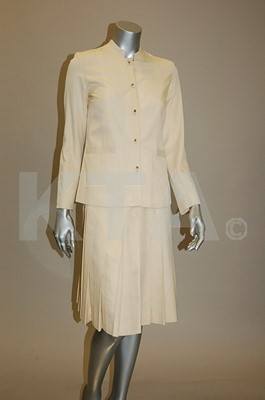 Lot 39 - A Chanel boutique cream silk suit, 1970s,...