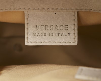 Lot 11 - A Versace 'Snap Out Of It' white and metallic...